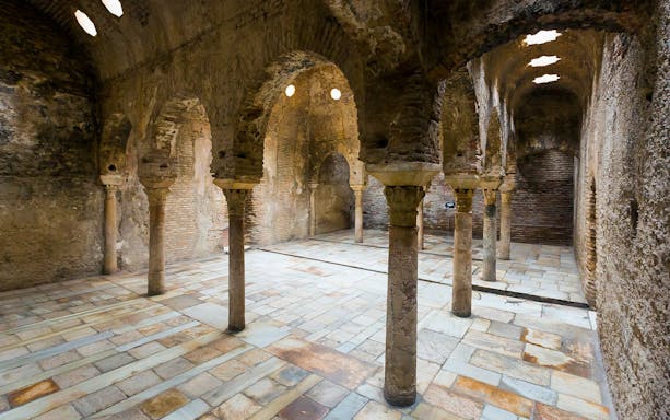 Interior of ancient Arab bathhouse with stone arches in Albaicin, Granada, Spain.