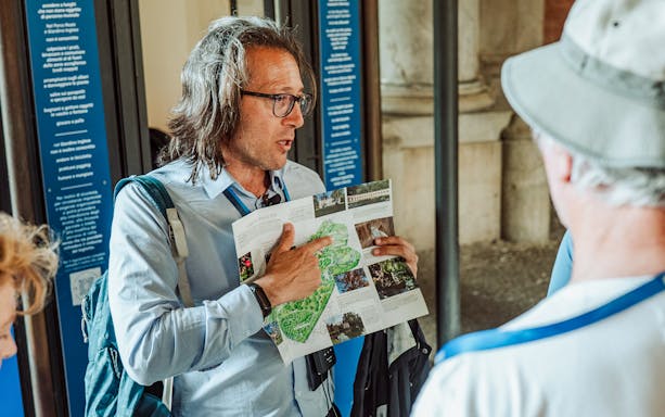Guide explaining map during Royal Palace of Caserta small-group tour.