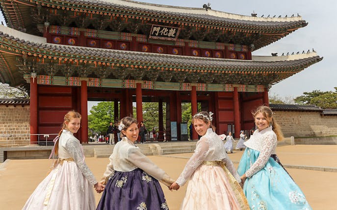Visitors in traditional hanbok at Gyeongbokgung Palace, Seoul.
