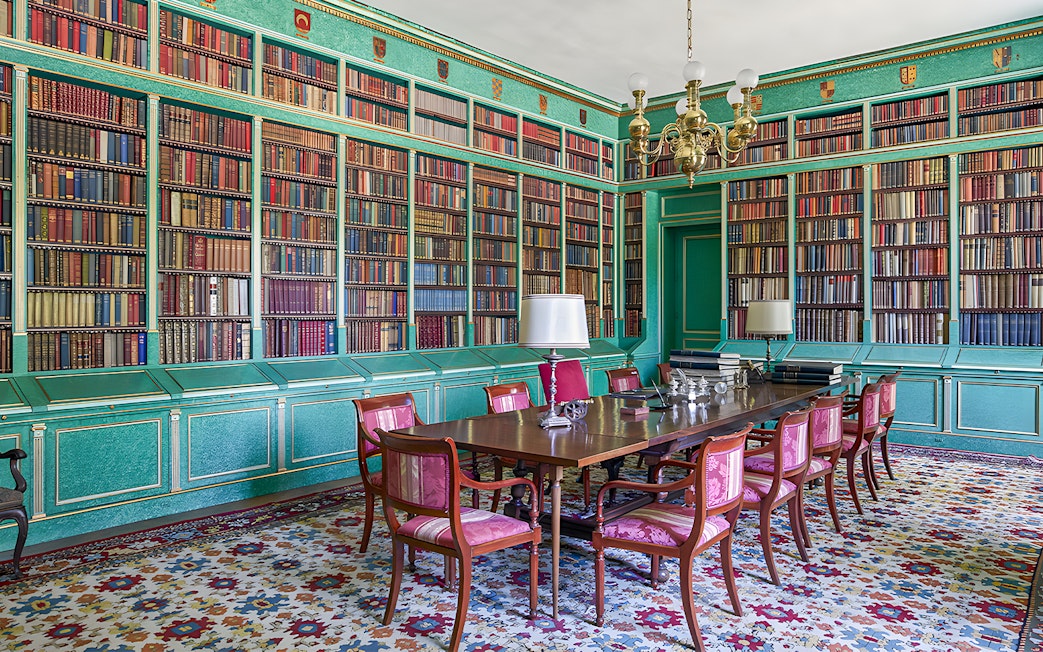 Liria Palace library with ornate bookshelves and historical artifacts in Madrid.