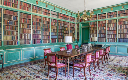 Liria Palace library with ornate bookshelves and historical artifacts in Madrid.