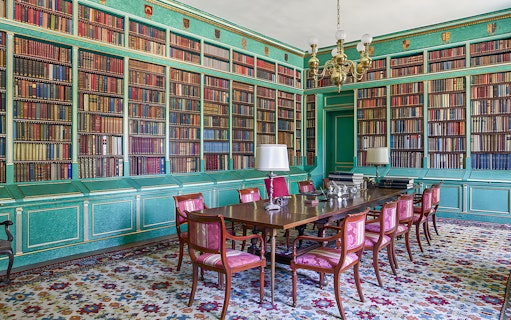 Liria Palace library with ornate bookshelves and historical artifacts in Madrid.