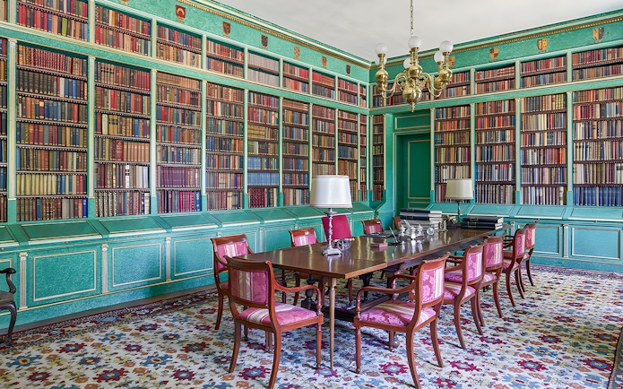 Liria Palace library with ornate bookshelves and historical artifacts in Madrid.