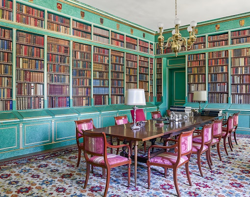 Liria Palace library in Madrid with ornate bookshelves and historical artifacts.
