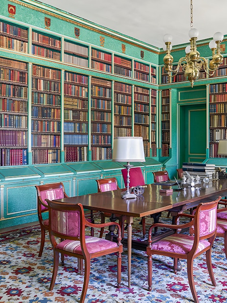 Liria Palace library with ornate bookshelves and historical artifacts in Madrid.