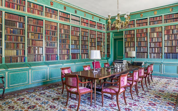 Liria Palace library with ornate bookshelves and historical artifacts in Madrid.