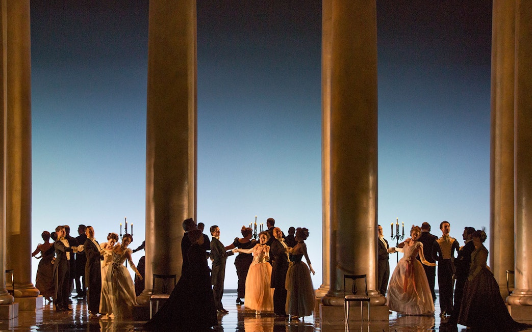 Dancers in formal attire performing on stage during Eugene Onegin Broadway show.