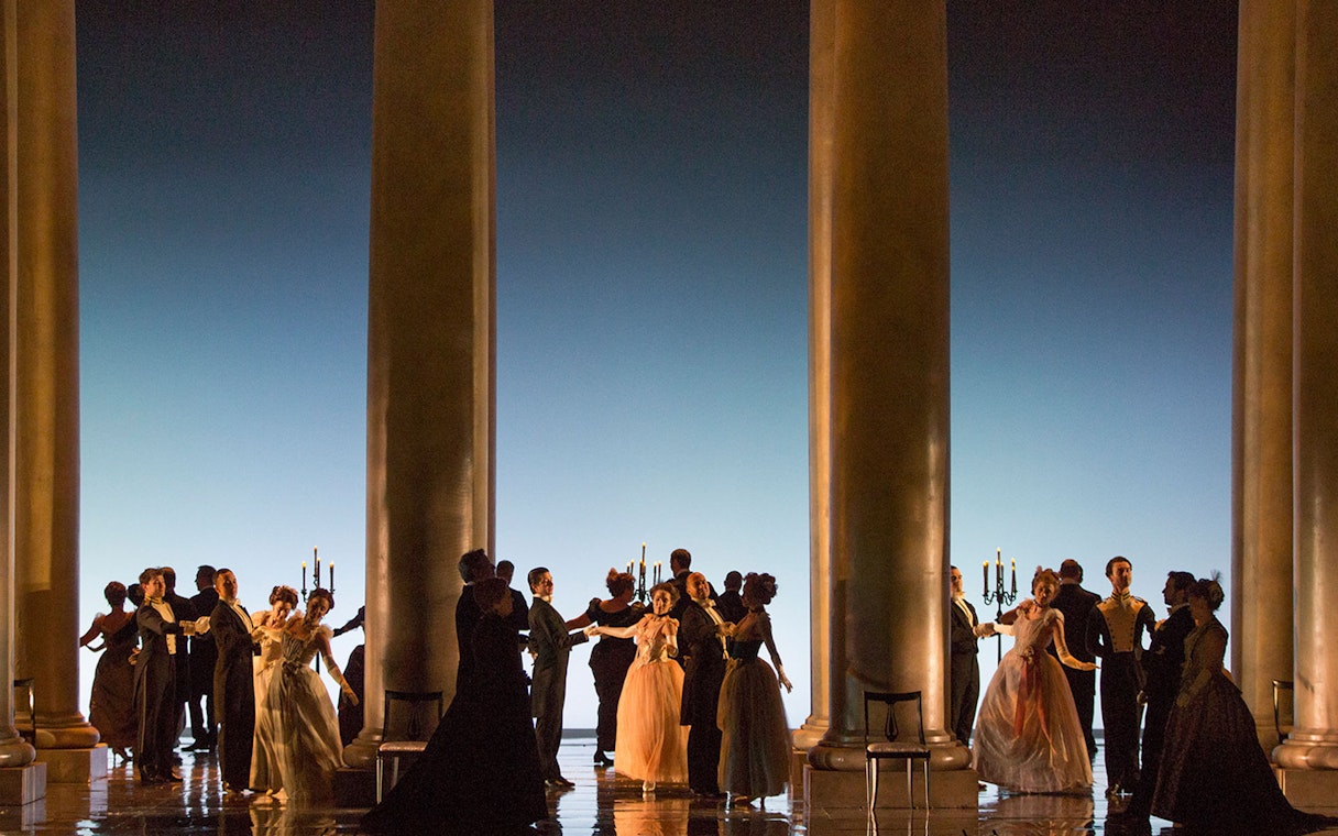 Dancers in formal attire performing on stage during Eugene Onegin Broadway show.
