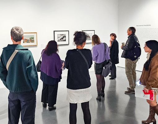Visitors looking at paintings