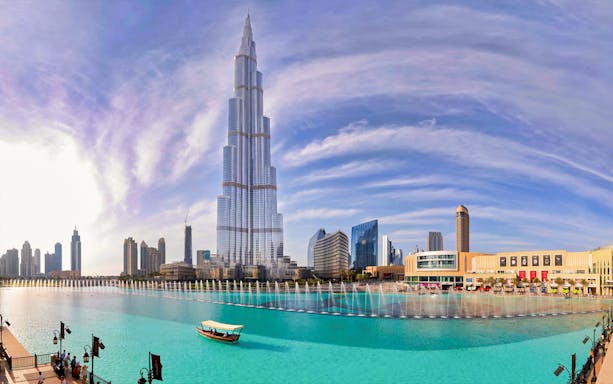 Burj Khalifa with Dubai Fountain and skyline, view from Abu Dhabi tour.