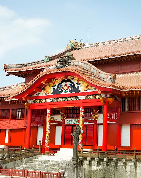 Shurijo Castle Park entrance with traditional red and gold architecture in Okinawa, Japan.