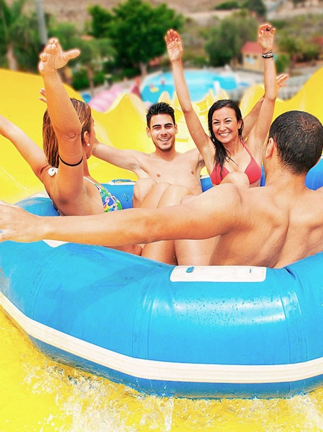 Group enjoying a water slide ride at Aqualand Maspalomas.