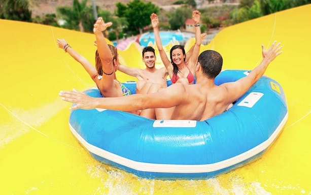 Group enjoying a water slide ride at Aqualand Maspalomas.