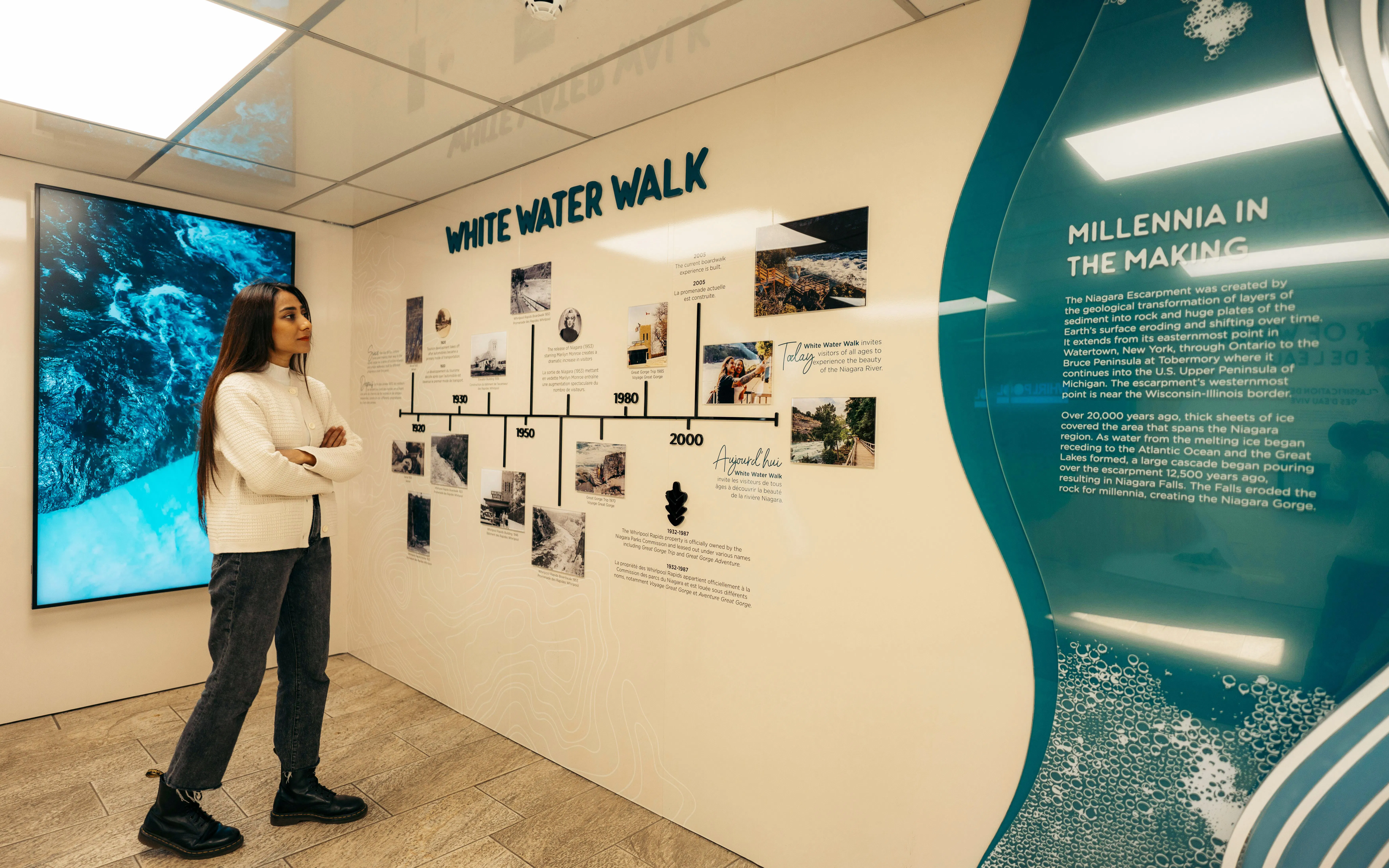 Visitor observing timeline display at White Water Walk exhibit.