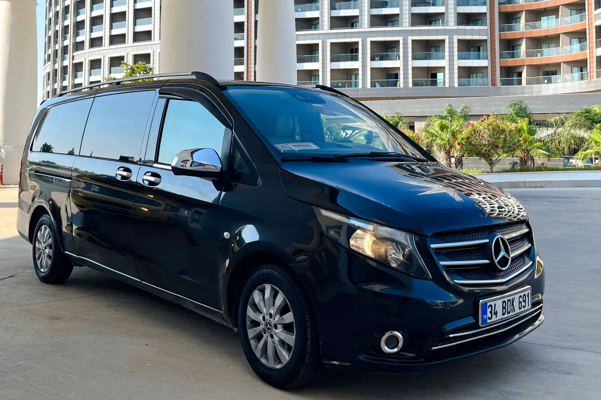 Black Mercedes van for VIP airport transfer in Antalya, parked outside a hotel.
