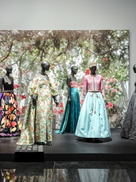 Fashion exhibit at YSL Museum in Marrakech showcasing colorful designer dresses.