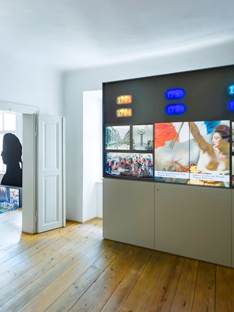 Mozarthaus Vienna exhibit with historical displays and portrait, featuring entry to audio-guided tour.