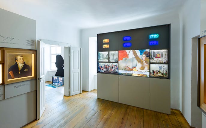 Mozarthaus Vienna exhibit with historical displays and portrait, featuring entry to audio-guided tour.