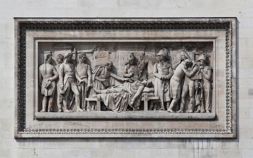 Relief sculpture on Arc de Triomphe depicting historical figures in Paris.