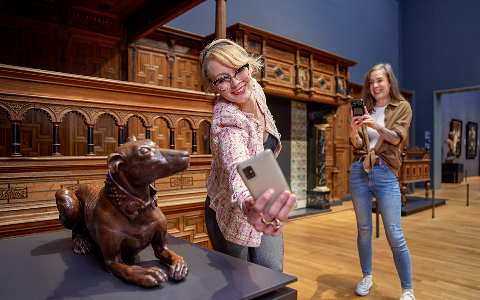 Visitors taking photos in the 17th century galleries at Rijksmuseum.
