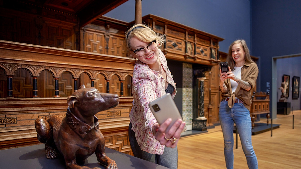 Visitors taking photos in the 17th century galleries at Rijksmuseum.