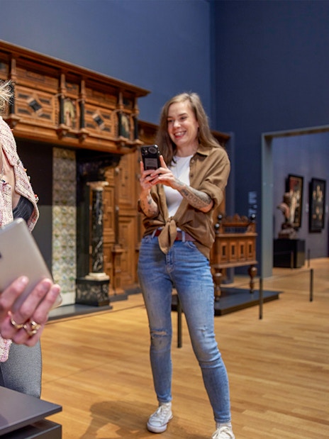 Visitors taking photos in the 17th century galleries at Rijksmuseum.