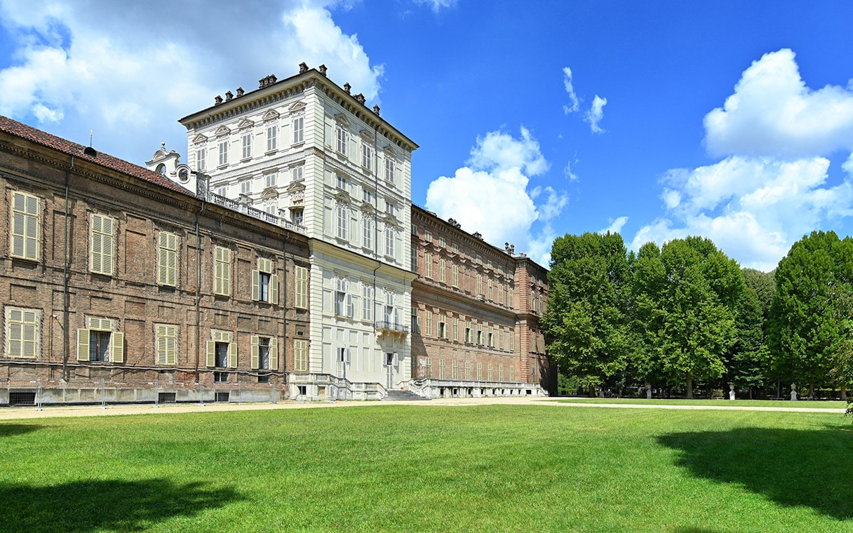 Royal Palace Museum exterior with lush gardens and clear blue sky.