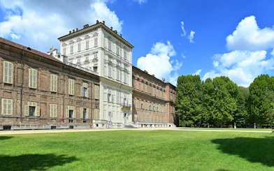 Royal Palace Museum exterior with lush gardens and clear blue sky.