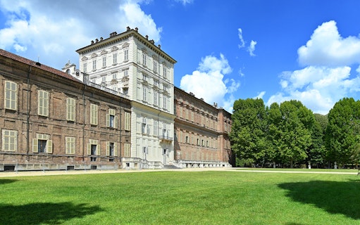 Royal Palace Museum exterior with lush gardens and clear blue sky.