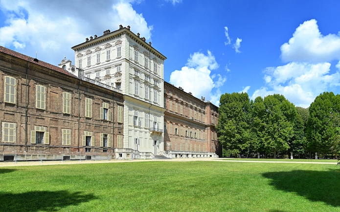 Royal Palace Museum exterior with lush gardens and clear blue sky.