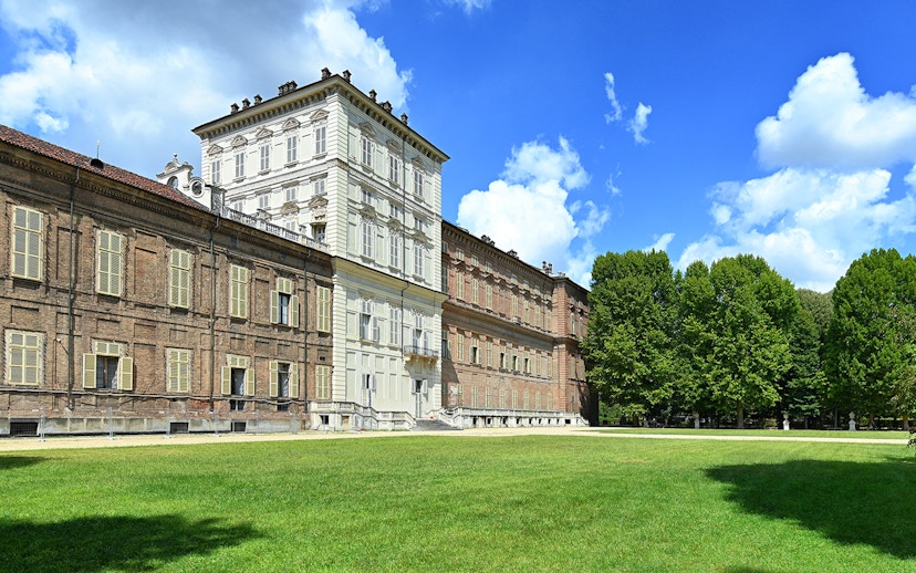 Royal Palace Museum exterior with lush gardens and clear blue sky.