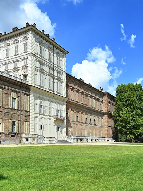 Royal Palace Museum exterior with lush gardens and clear blue sky.
