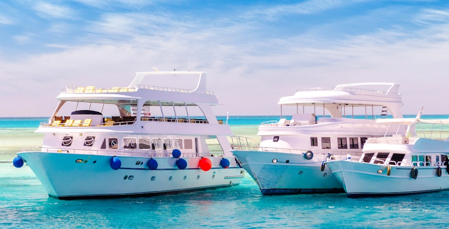 Cruise yachts on clear water near coral reef, Hurghada Sea Trip.