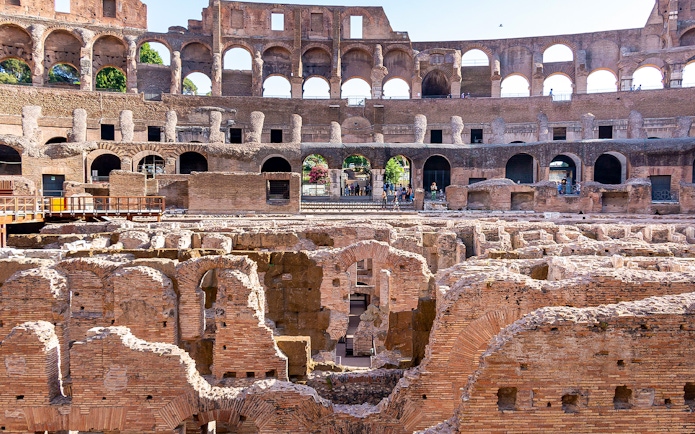 Gladiator arena ruins inside the Colosseum, Rome, showcasing ancient architecture.