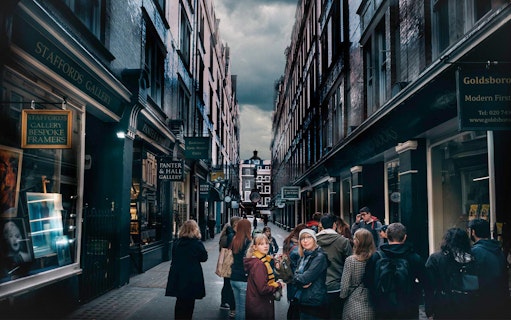 Visitors exploring Harry Potter film locations in a narrow London alley.