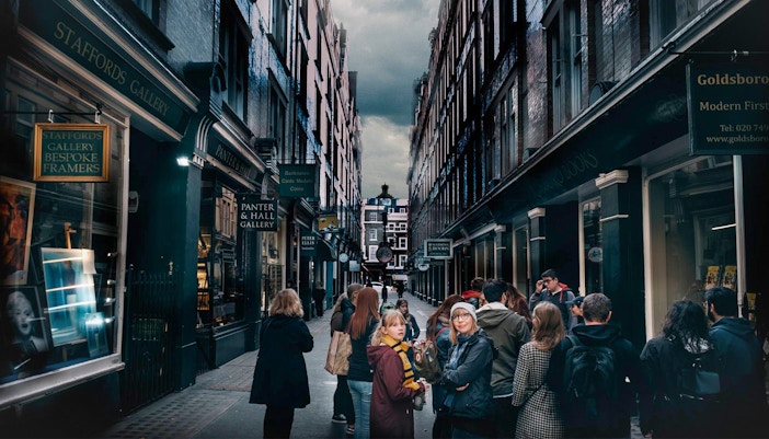 Visitors exploring Harry Potter film locations in a narrow London alley.