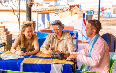 Tourists enjoying breakfast at a rooftop cafe in Morocco.