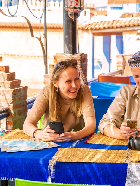 Tourists enjoying breakfast at a rooftop cafe in Morocco.