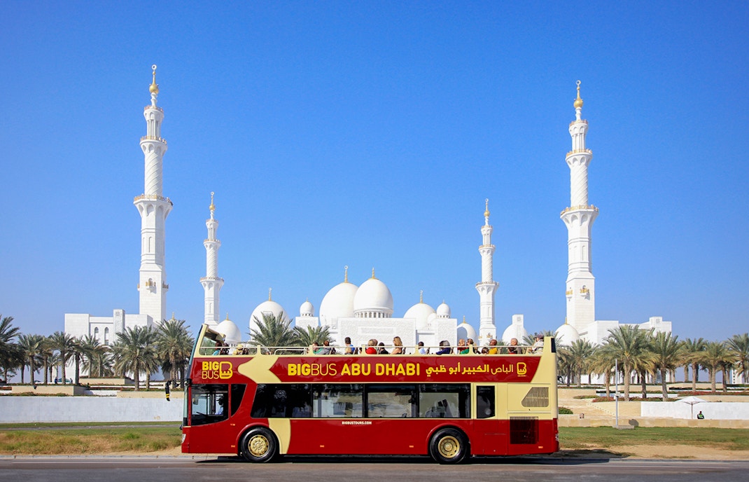 Big Bus Abu Dhabi tour with Nutcracker-themed decorations in front of Emirates Palace.