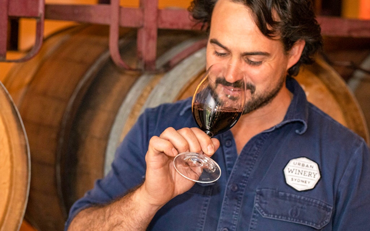 Person tasting wine at Urban Winery Sydney, part of Sydney Explorer Pass by Go City.