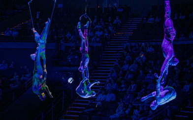 Acrobats performing aerial stunts at La Perle show in Dubai.