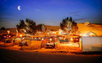 Private cabanas under a starry sky in a desert oasis, Dubai.