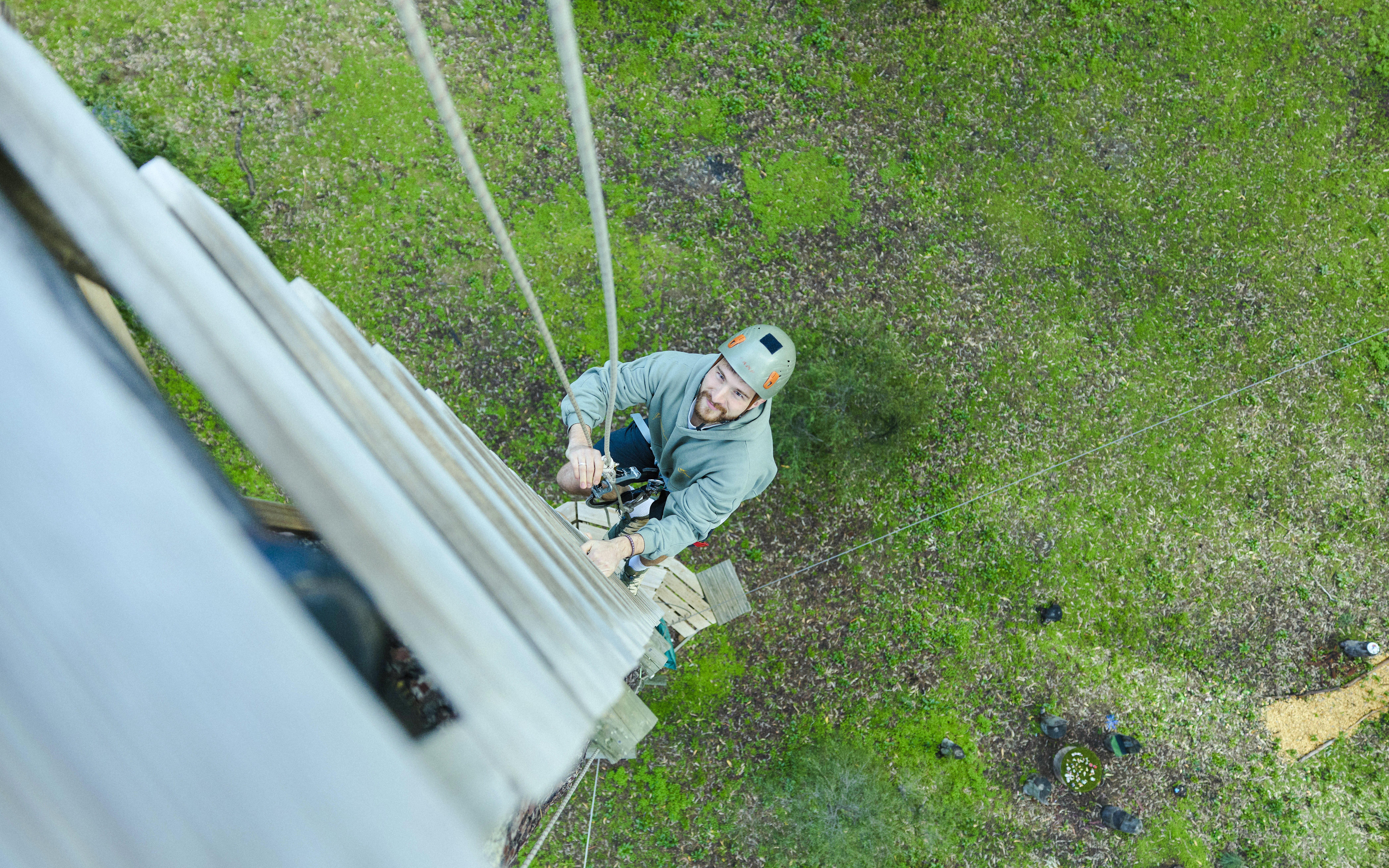 Man climbing high ropes course in Busselton forest adventure.