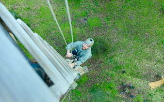 Man climbing high ropes course in Busselton forest adventure.