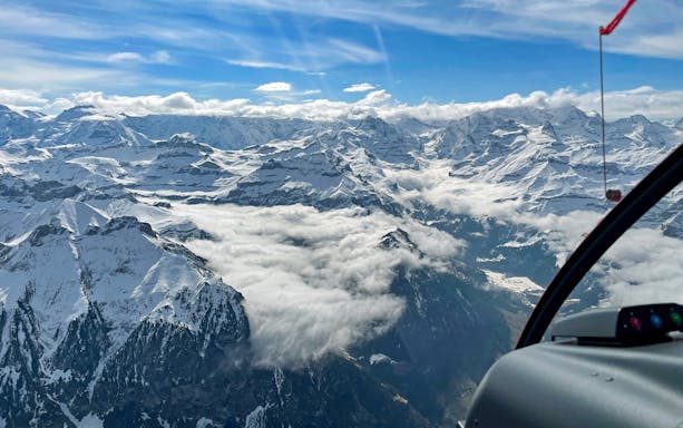 Scenic view of snow-covered Swiss Alps from a private helicopter flight.
