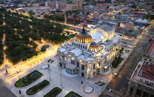 Aerial view of Palacio de Bellas Artes in Mexico City at dusk.