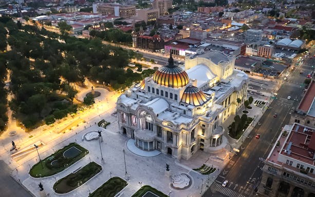 Aerial view of Palacio de Bellas Artes in Mexico City at dusk.