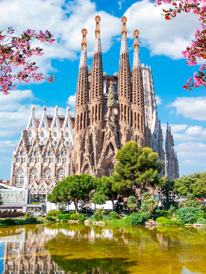 Sagrada Familia Cathedral with blooming trees in spring, Barcelona.