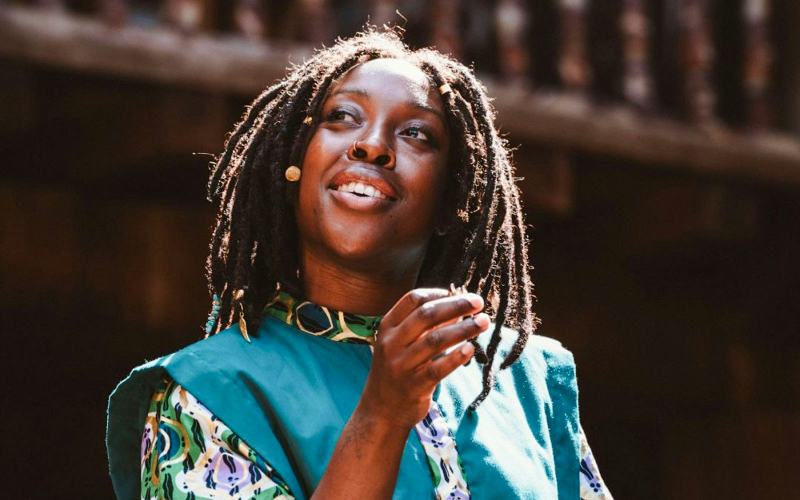 Performer in Twelfth Night, or What You Will, on stage in vibrant costume.
