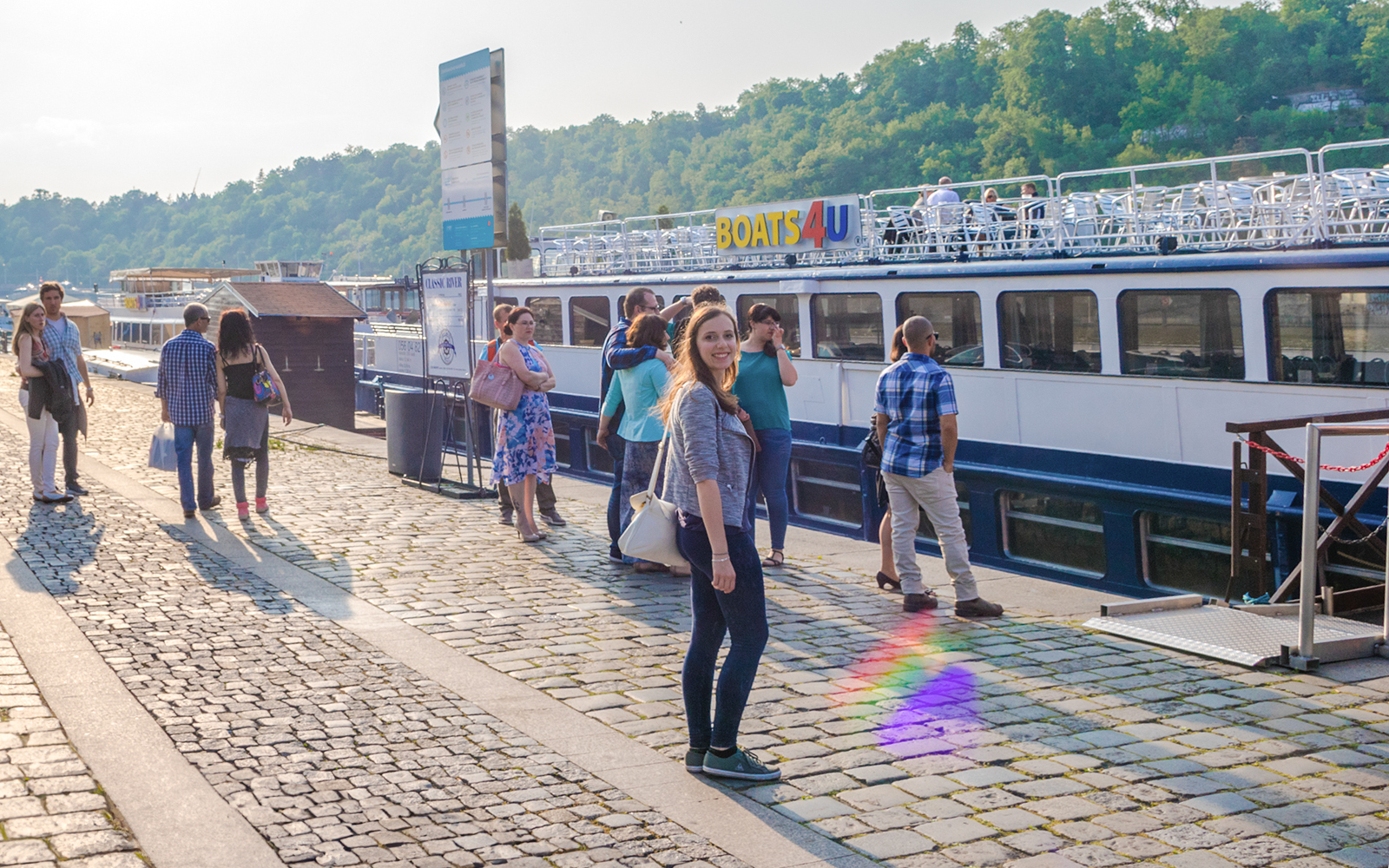 Tourists boarding a boat for a 1-hour panoramic cruise on the Vltava River.